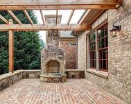 Outdoor Fireplace w/ Cedar Trellis in home built by Atlanta Home Builder Waterford Homes