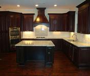 Classic Dark Cherry Cabinetry w/ Subway Tile Backsplash and Tile Insert over Cooktop